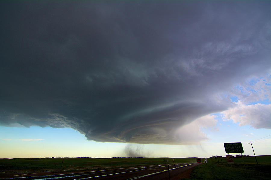 Rotating Supercell Storm Over Highway, With Streaks Indicating Falling