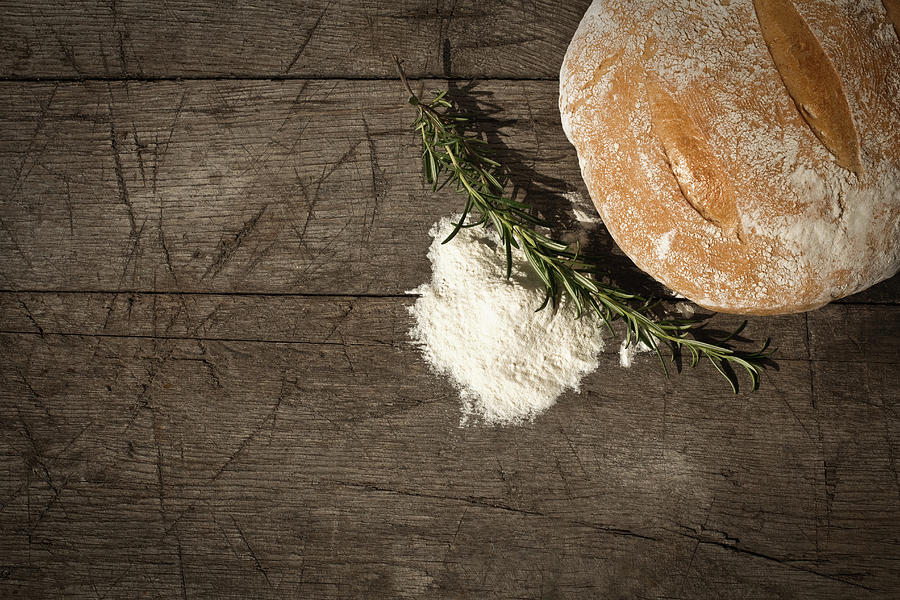 Round Bread On A Wooden Table Photograph by Infrontphoto