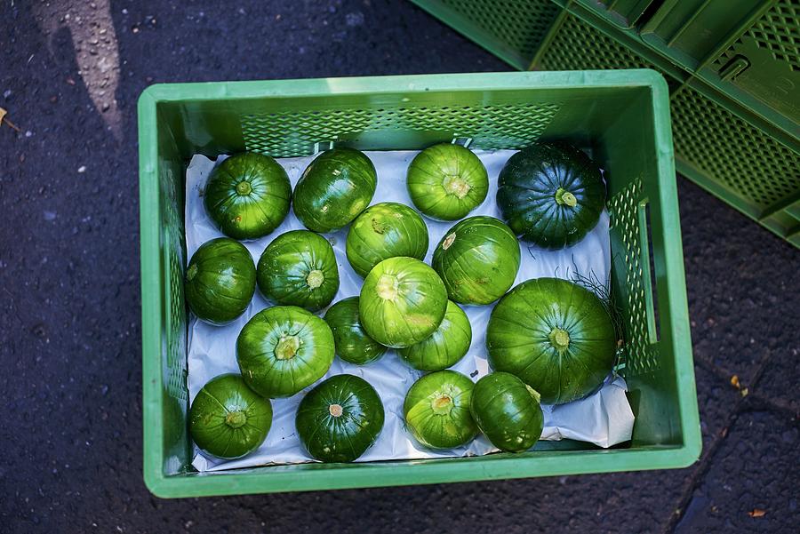 Round Courgettes In A Crate Photograph by Bernhard Winkelmann