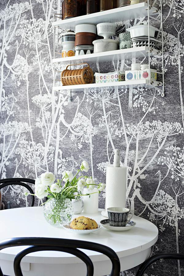 Round Table And String Shelves Hung On Floral Wallpaper Photograph by Cecilia Mller