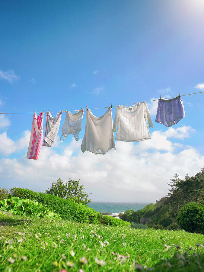 Row Of Fresh Laundry On Clothes Line In Coastal Garden by Frank And Helena