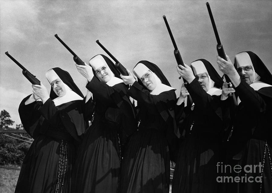 Row Of Nuns Aiming Rifles Photograph by Bettmann