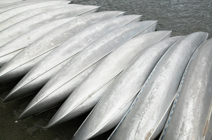 Row Of Overturned Canoes Photograph by Richard Drury