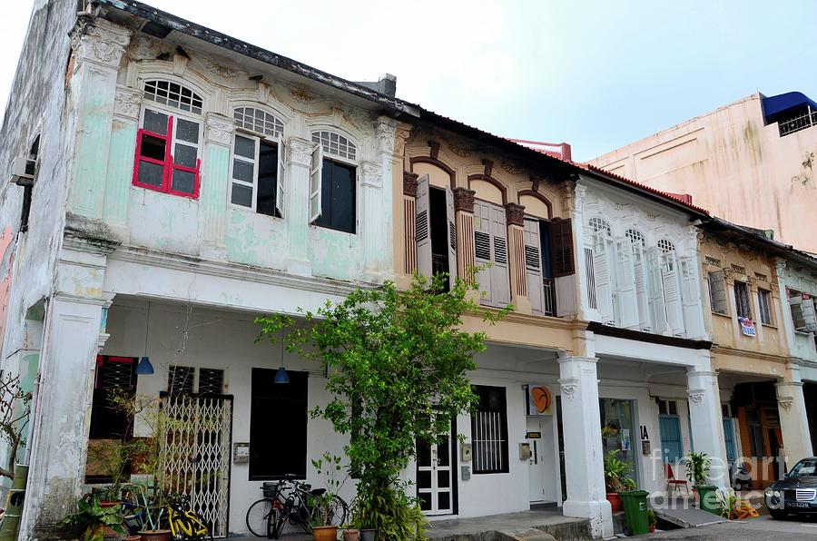 Row of weathered shophouses with bicycles and windows Kampong Glam Singapore Photograph by Imran Ahmed