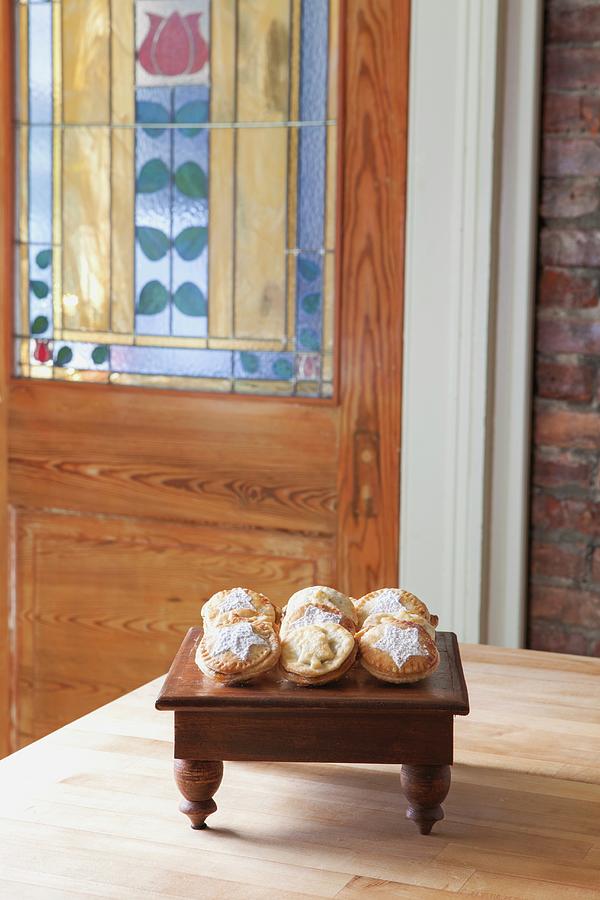 Rows Of Mince Pies On A Small Wooden Table In A Living Room Photograph by Amy Kalyn Sims