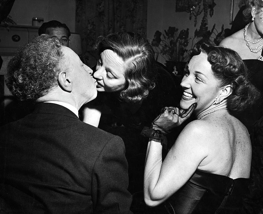 Black And White Photograph - Rubinstein Kisses Bankhead At Hedda Hoppers Party by Ed Clark