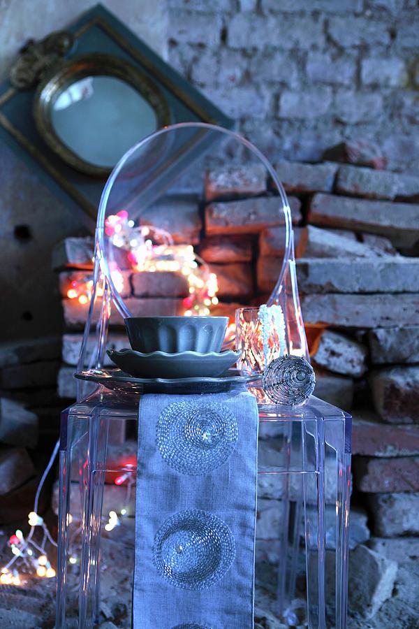 Runner And Cafe Au Lait Bowl On Ghost Chair In Front Of Rustic Stone Wall With String Of Fairy Lights Photograph by Michal Mrowiec