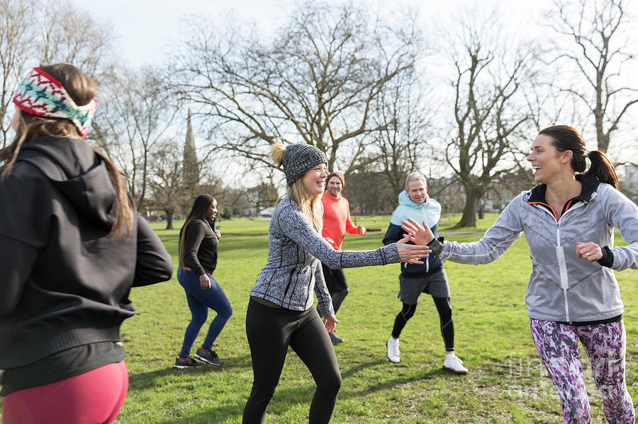 Runners Jogging In A Circle In Park Photograph by Caia Image/science ...