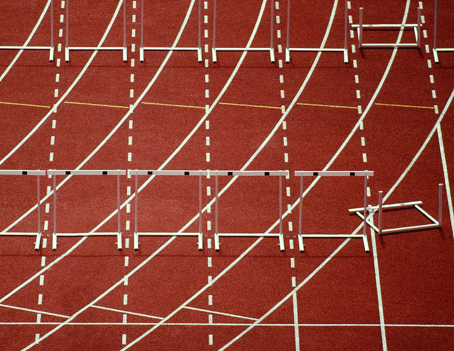 Running Track With Knocked Down Hurdles Photograph by Grant Faint