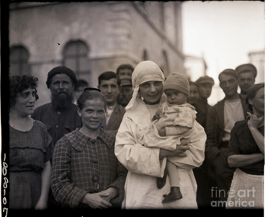 Russian Nurse Smiles As She Holds Child Photograph by Bettmann