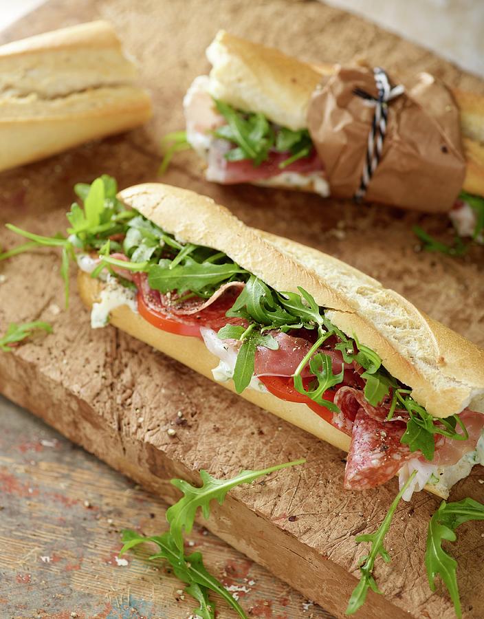 Rustic Baguette With Serrano Ham, Salami, Rocket And Tomato Photograph by Artfeeder