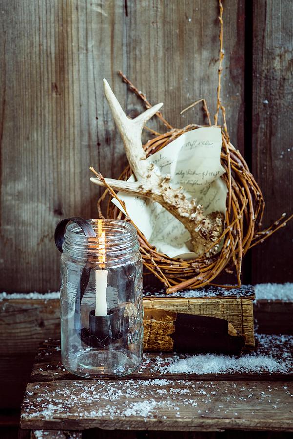 Rustic Christmas Arrangement Of Willow Wreath, Antlers And Candle Photograph by Eising Studio