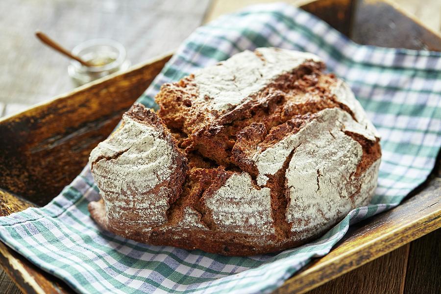 Rustic Country Bread On A Checked Napkin Photograph by Herbert Lehmann
