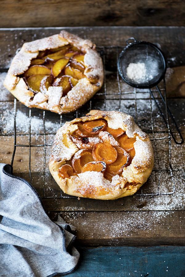 Rustic Galettes With Fruit And Icing Sugar Photograph by Hein Van Tonder