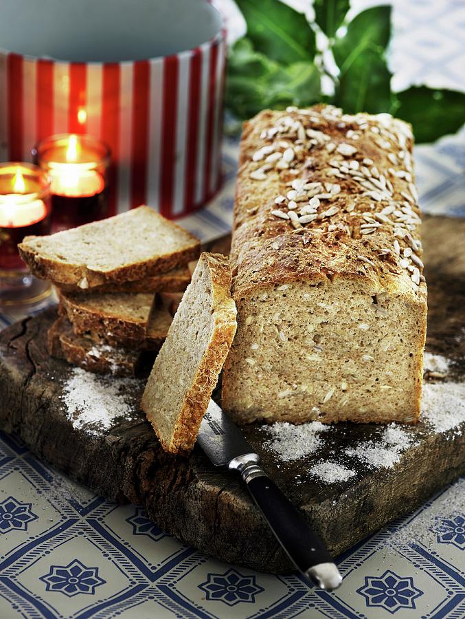 Rustic Wholemeal Bread On A Wooden Board For Christmas Photograph by Mikkel Adsbl