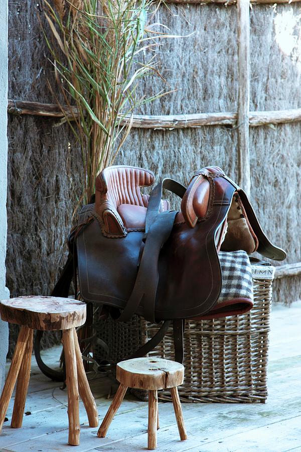 Rustic Wooden Stool Next To Saddle On Top Of Basket Outdoors Photograph by Christophe Madamour