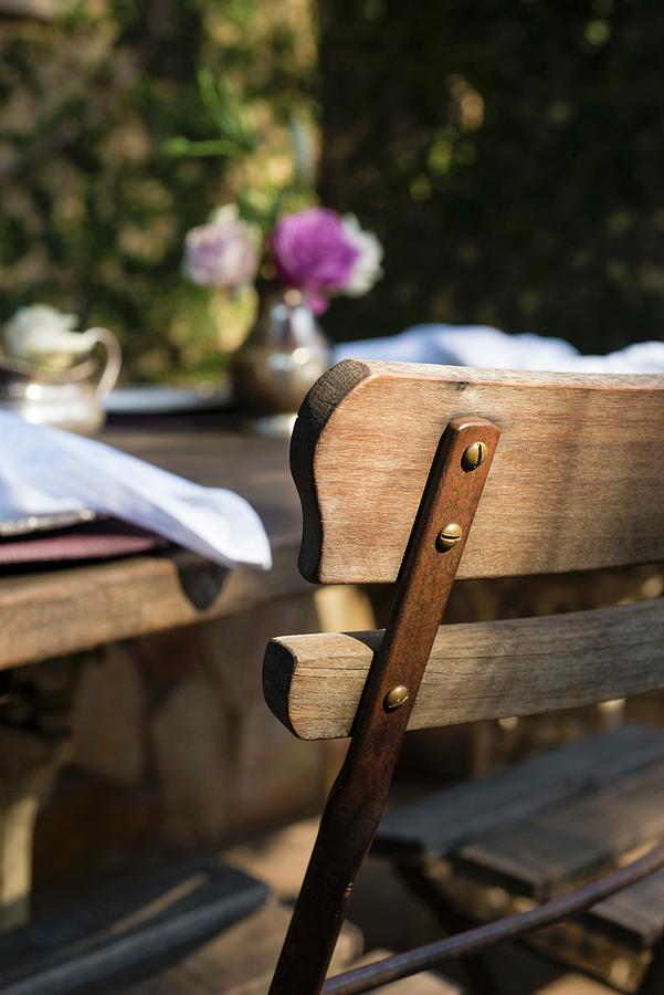 Rustic Wooden Table And Chair On Restaurant Terrace Photograph by Great Stock!