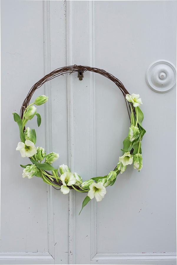 Rustic Wreath Made From Rusty Wire And Tulips On Cupboard Door Photograph by Irene Berni