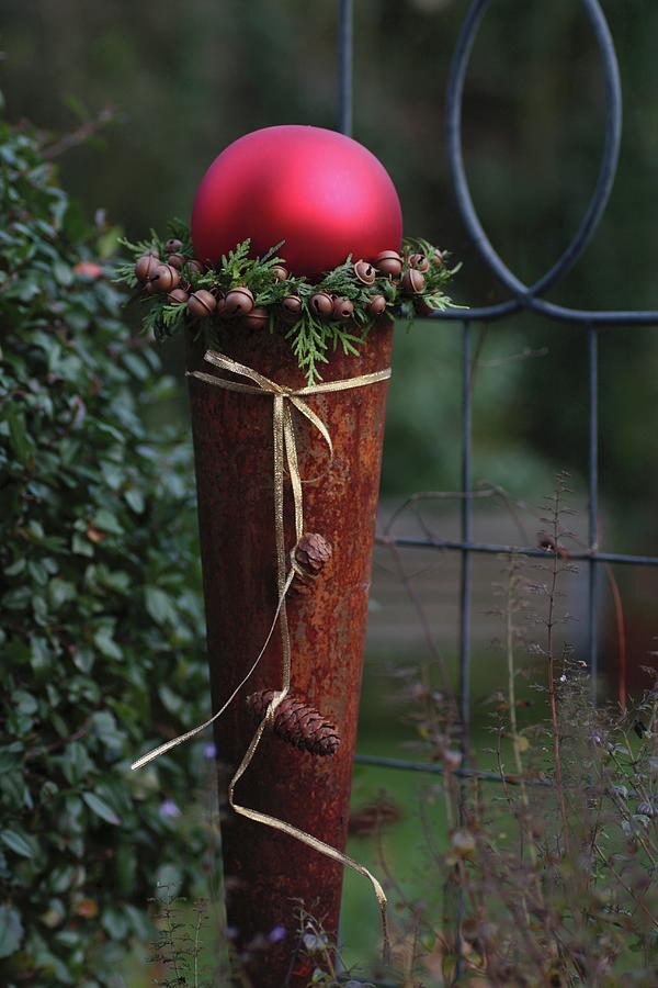 Rusty Cone Topped With Large, Red Bauble Framed With A Wreath Of Thuja ...