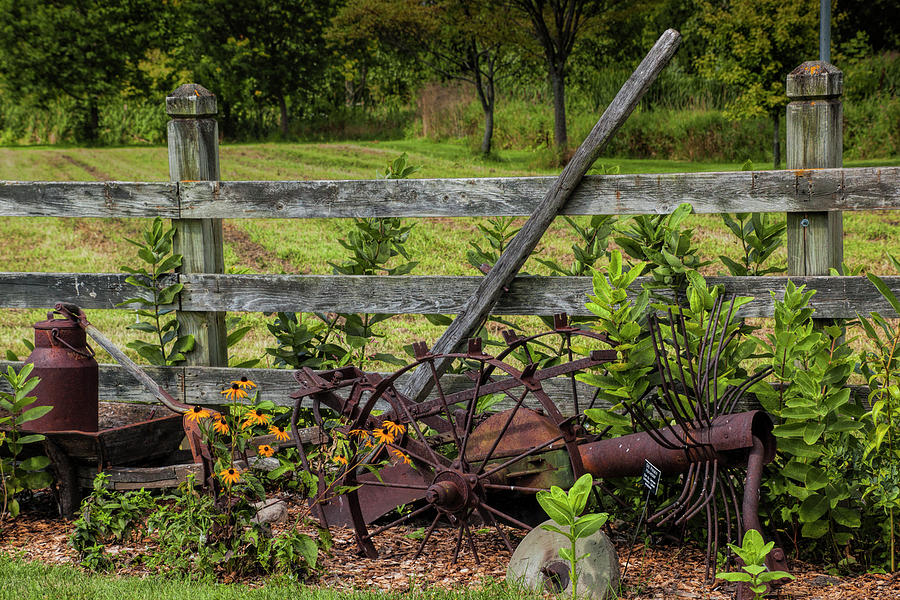 Rusty Farm Tools by a Rustic Wooden Fence Photograph by Randall Nyhof