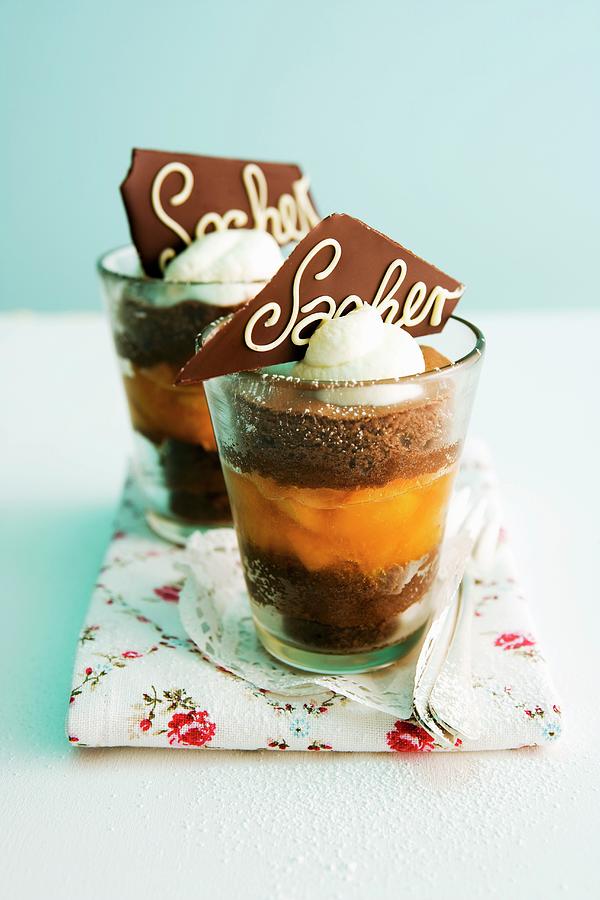 Sachertorte With Apricot Compote In Glasses Photograph by Michael Wissing