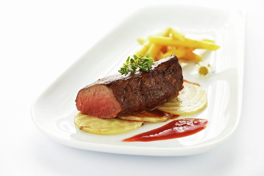 Saddle Of Venison With Fried Sugar Beet, Potato Pasta And Cornelian Cherry Coulis Photograph by Lehmann, Herbert