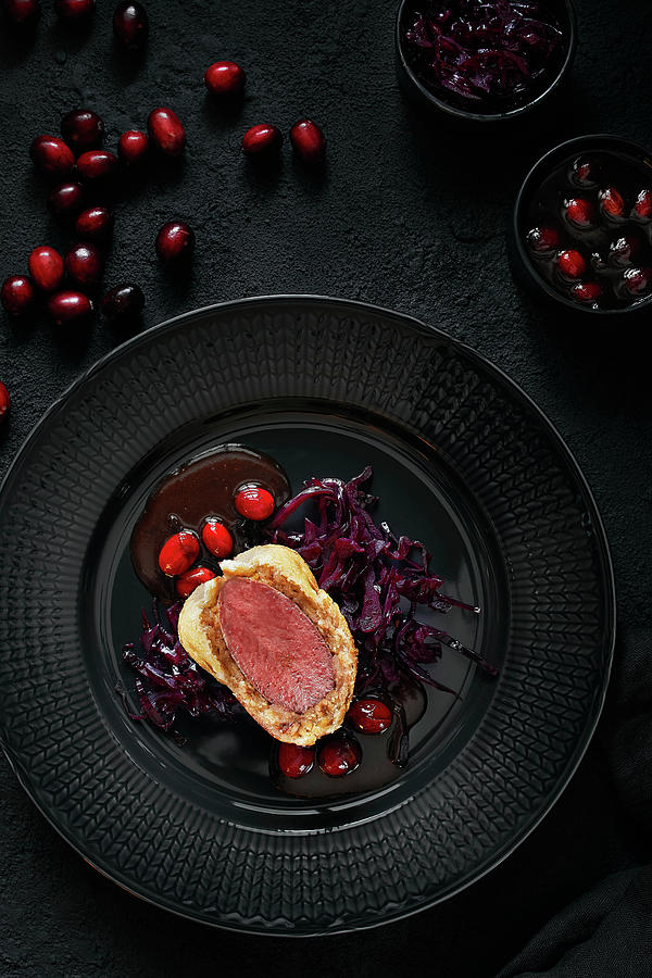 Saddle Of Venison Wrapped In Stollen With Marinated Red Cabbage And Cranberry Jus Photograph by Bjrn Llf