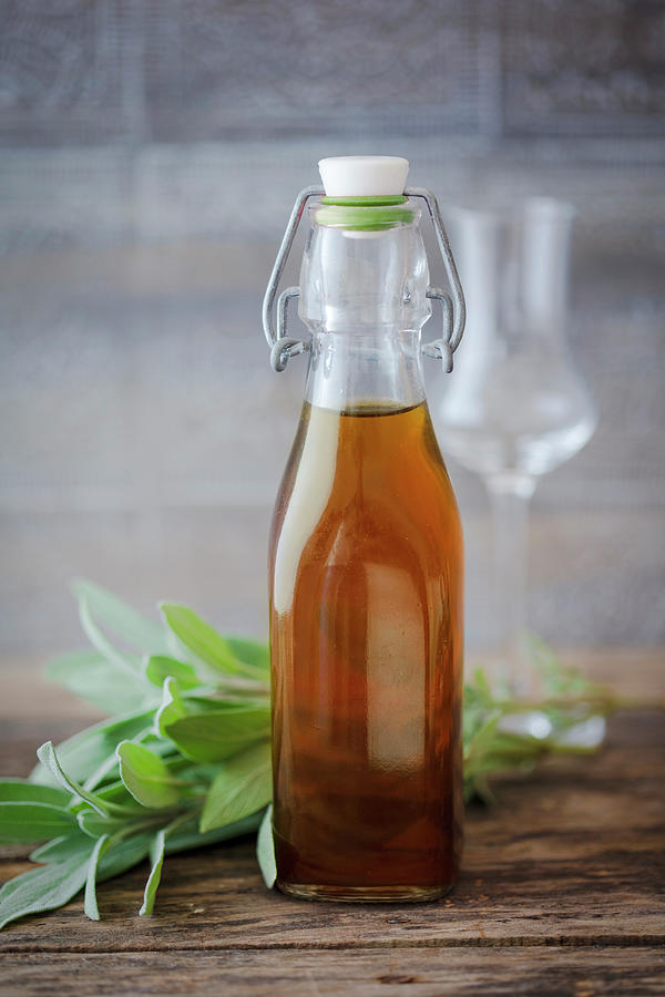 Sage Liqueur In A Flip-top Bottle Photograph by Jan Wischnewski