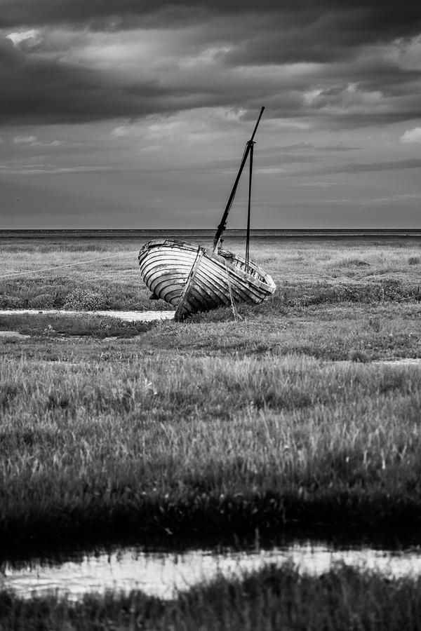 Sail boat moored on the salt marsh, Norfolk Photograph by Anita Nicholson