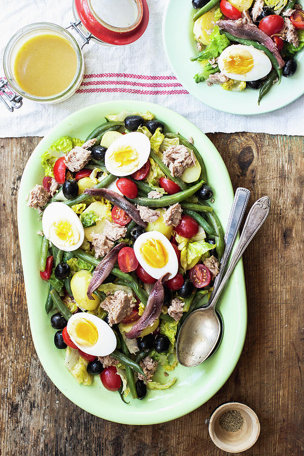 Salad Nicoise With Romain Lettuce, Cherry Tomatoes, Tuna, Green Beans, Black Olives, Anchovies And Hard-boiled Eggs Photograph by Zuzanna Ploch
