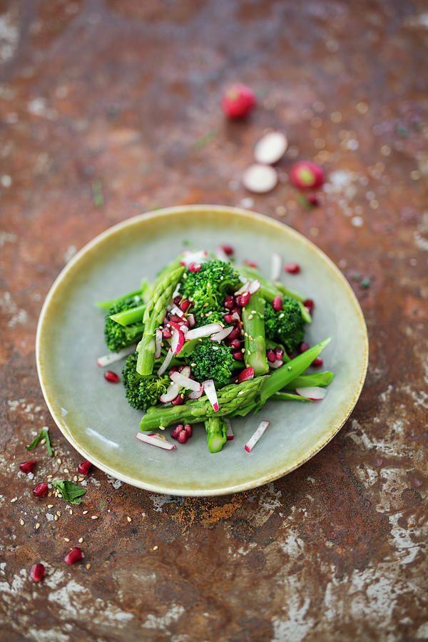 Salad With Broccoli Stems, Radishes, Pomegranate And Green Asparagus Photograph by Jan Wischnewski