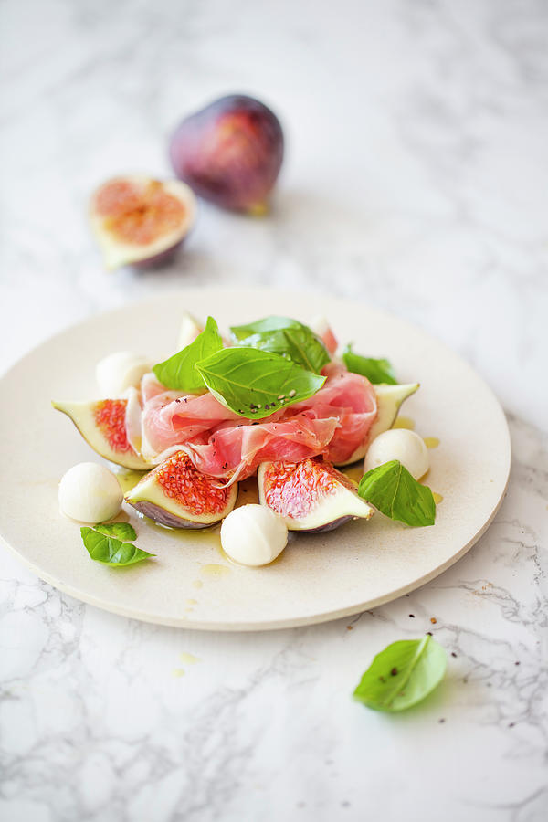 Salad With Fresh Figs, Mozzarella, Parma Ham And Basil Photograph by Jan Wischnewski