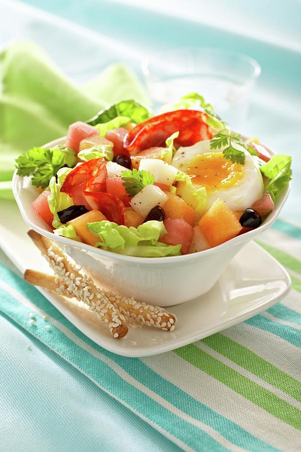 Salad With Salami, Half An Egg, Melon And Olives Photograph by Alessandra Pizzi