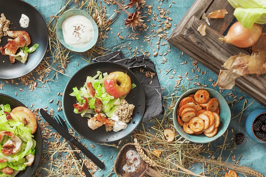 Salad With Turkey Strips And Baked Apples On An Autumnal Laid Table Photograph by Birgit Twellmann