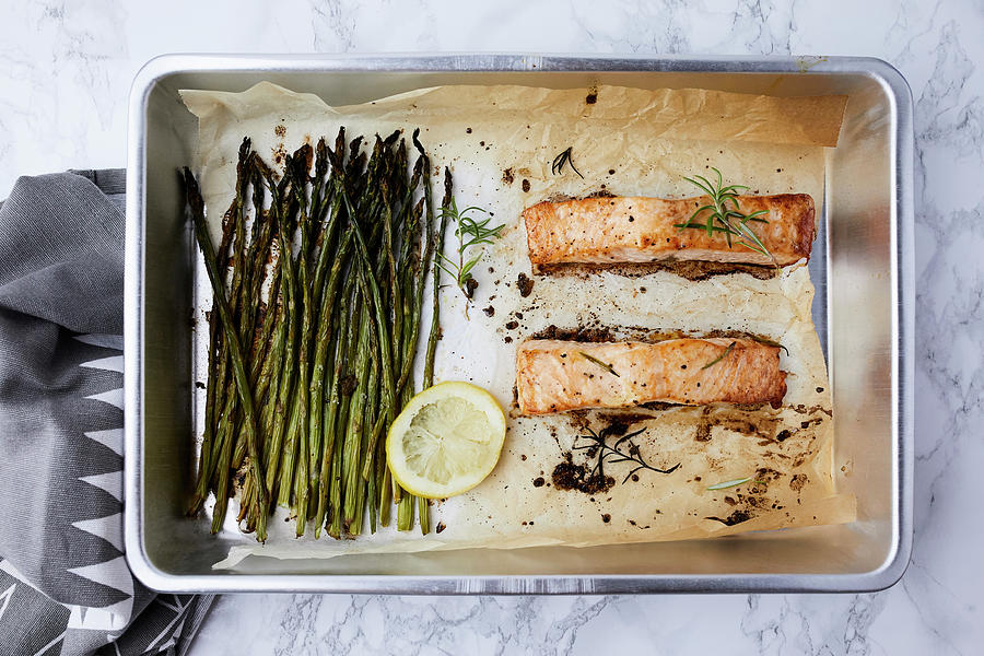 Salmon And Asparagus Baked In The Oven, Seasoned With Olive Oil And Rosemary Photograph by Natasa Dangubic