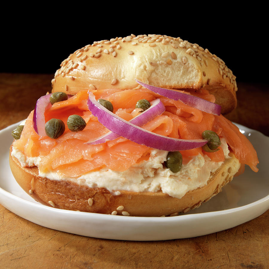Salmon And Cream Cheese On Sesame Bagel With Capers And Red Onions Photograph by Paul Poplis