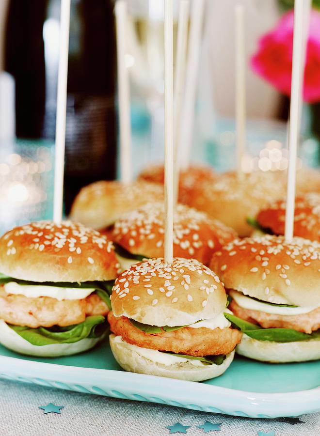 Salmon Burgers In Sesame Seed Buns On Wooden Skewers Photograph by Huerta, Anna