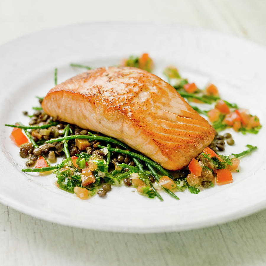 Salmon Fillet On A Bed Of Samphire, Green Lentles And Tomatoes With A Green Herb Vinegarette Photograph by Clive Sherlock