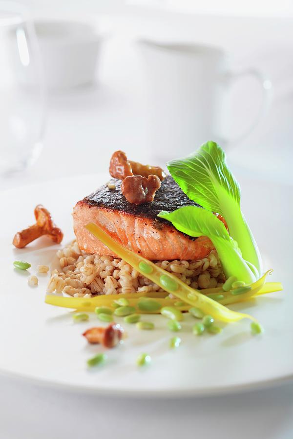 Salmon Fillet With Chanterelle Mushrooms On A Bed Of Barley Photograph by Lukasz Zandecki
