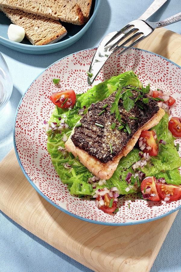 Salmon On A Bed Of Grilled Savoy Cabbage With Tomatoes And Onions Photograph by Alessandra Pizzi