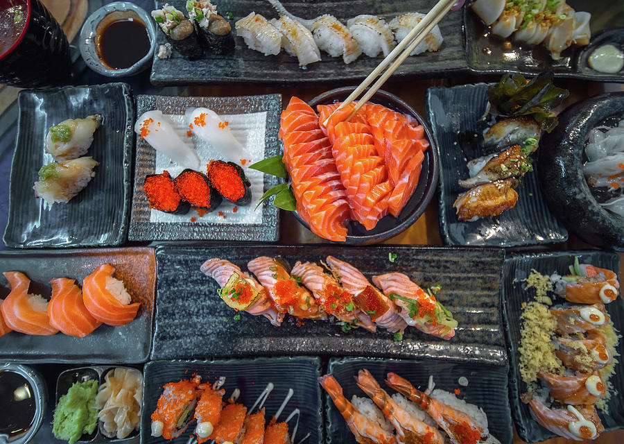 Salmon sashimi and other seafood and sushi on the party table Photograph by Anek Suwannaphoom