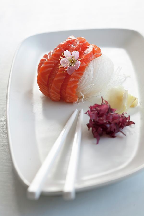 Salmon Sashimi On Radish Strips With A Cherry Flower Photograph by Martina Schindler
