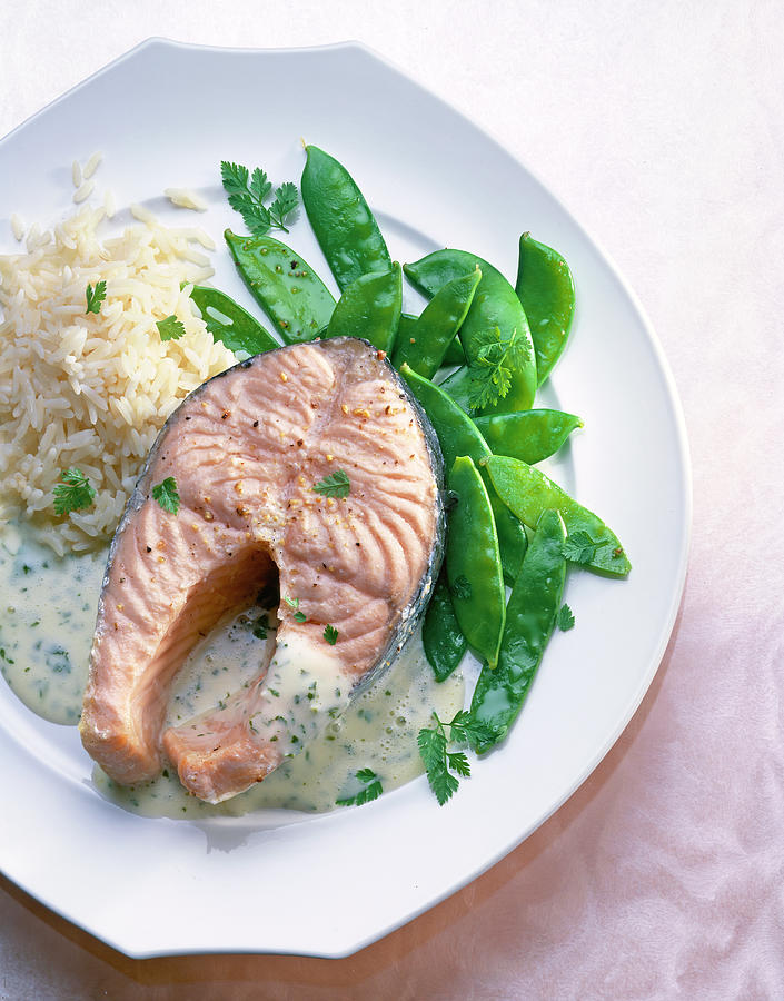 Salmon Steak With Sugar Peas, Rice, Sauce And Chervil On Dish Photograph by Jalag / Uwe Bender