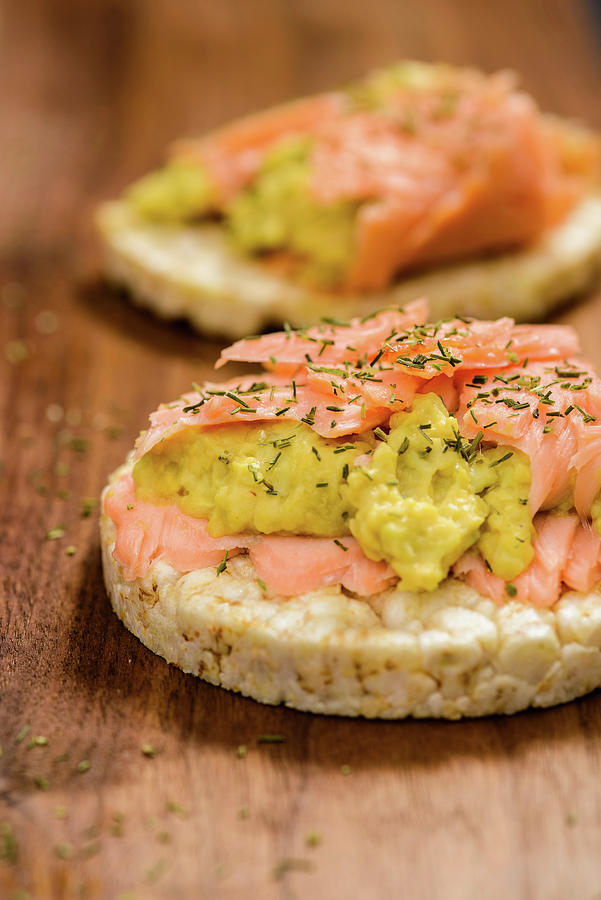 Salmon With Avocado Cream On Rice Crackers Photograph by Rita Newman