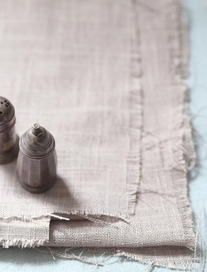 Salt And Pepper Shakers On A Light Linen Cloth Photograph by Great Stock!