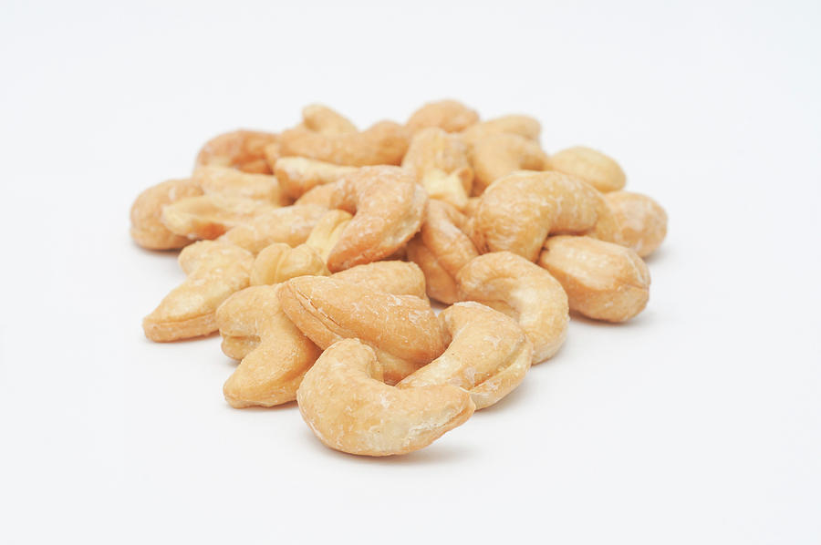 Salted Cashews On A White Surface Photograph by Clarke Cond