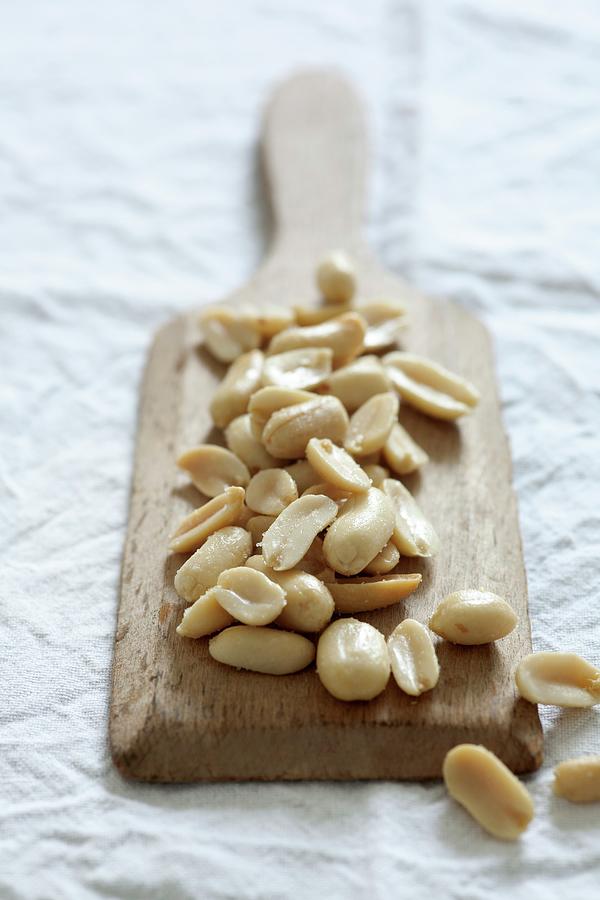 Salted Peanuts On A Small Wooden Board Photograph by Victoria Firmston