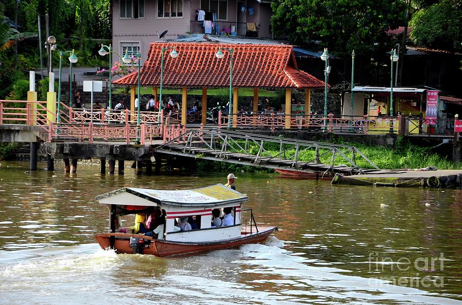 Sampan boat river ferry takes commuters across Sarawak River Kuching Malaysia Photograph by Imran Ahmed