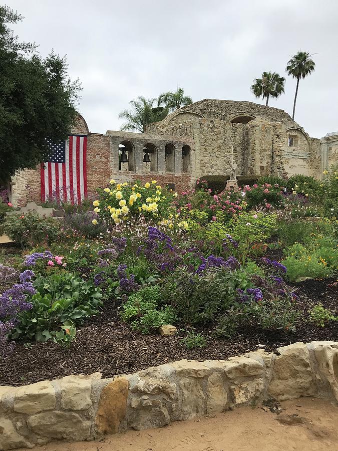 San Juan Capistrano Mission with flag Photograph by Cindy Bale Tanner
