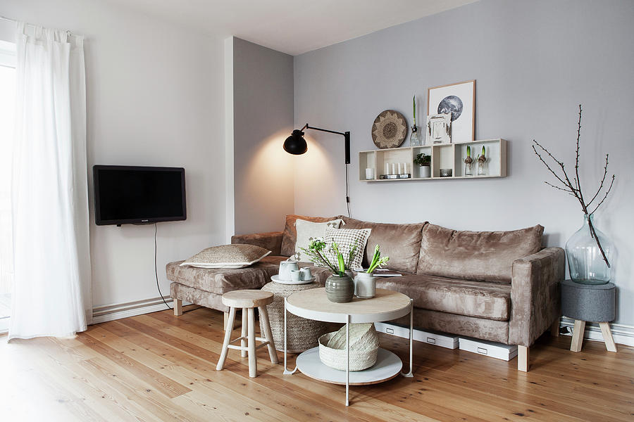 Sand-coloured Sofa, Wall-mounted Lamp And Coffee Table With Vases Of White Flowers Photograph by Hej.hem Interior
